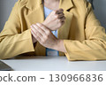 Woman hand with wrist pain numbness and pain in the palm of the hand has pain and tingling in the nerve endings This is a side effect of sitting and working for a long time on a laptop at the office 130966836