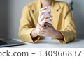 Woman hand with wrist pain numbness and pain in the palm of the hand has pain and tingling in the nerve endings This is a side effect of sitting and working for a long time on a laptop at the office 130966837