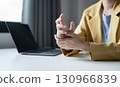 Woman hand with wrist pain numbness and pain in the palm of the hand has pain and tingling in the nerve endings This is a side effect of sitting and working for a long time on a laptop at the office 130966839