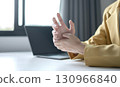 Woman hand with wrist pain numbness and pain in the palm of the hand has pain and tingling in the nerve endings This is a side effect of sitting and working for a long time on a laptop at the office 130966840