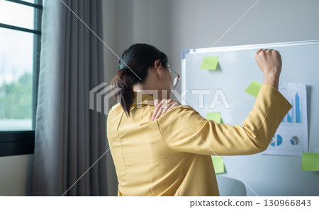 Woman having shoulder pain pain during work long time. stretching to relax and relax while working hard at the office Woman having shoulder pain pain during work long time. stretching to relax and relax while working hard at the office 130966843