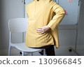 Woman having back body pain during work long time. stretching to relax and relax while working hard at the office 130966845