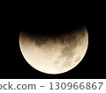 The moon floating in the night sky (full moon 5) Total lunar eclipse halfway through 130966867