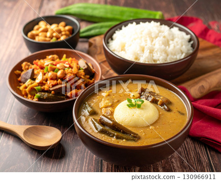 Traditional Nigerien fufu made from cassava and served beside a steaming peanut and okra soup. 130966911