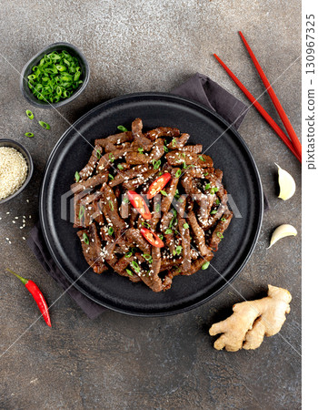 Asian teriyaki beef strips with spice, sesame on a gray background. Top view. Asian food. 130967325