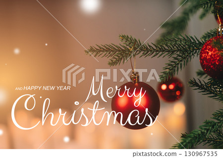 Christmas tree decoration with red ornaments and a festive greeting in soft lighting 130967535