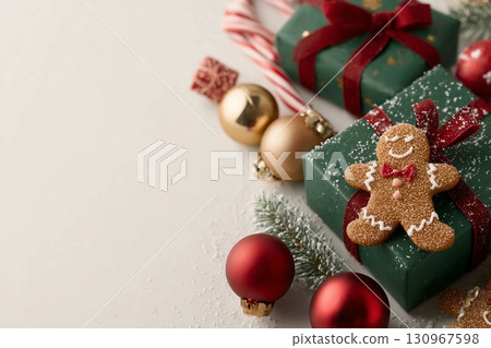 Delightful holiday tableau from top view emerald gift boxes, red, green, and golden baubles, gingerbread man ornament, jingle bells, candies, frosty fir twig, light background with space for greeting Delightful holiday tableau from top view emerald gift boxes, red, green, and golden baubles, gingerbread man ornament, jingle bells, candies, frosty fir twig, light background with space for greeting 130967598