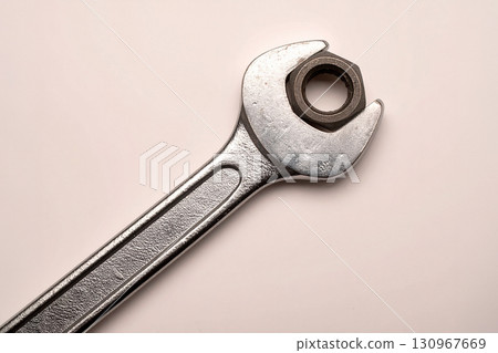 a wrench tightens a bolt 130967669
