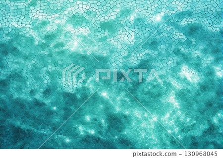 Clear turquoise swimming pool water with sparkling sunlight reflections and tile floor pattern 130968045