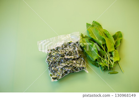 Frozen sorrel in a bag and a bunch of fresh sorrel 130968149