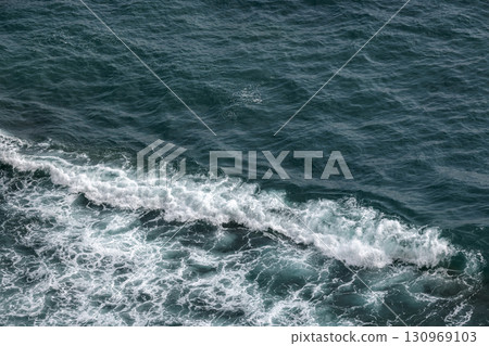 Aerial ocean view showcasing waves breaking along the coast Aerial ocean view showcasing waves breaking along the coast 130969103