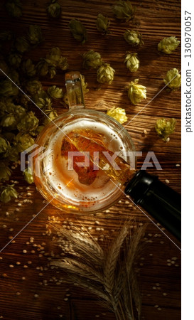 Pouring Beer into Pint Glass, Top Down View. Pouring Beer into Pint Glass, Top Down View. 130970057