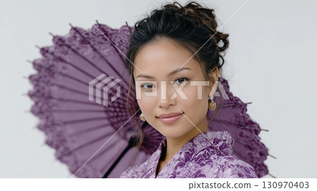 Beautiful Japanese woman in traditional attire holding a purple parasol Beautiful Japanese woman in traditional attire holding a purple parasol 130970403