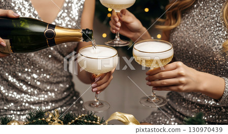 Women in shiny dresses pour champagne into glasses, celebrating a New Year or holiday party with luxury and joy. Women in shiny dresses pour champagne into glasses, celebrating a New Year or holiday party with luxury and joy. 130970439