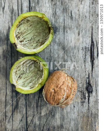 Walnut in Green and Hard Shell on Wooden Background 130971013
