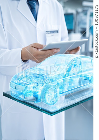 Auto engineer next to a holographic model of a car. Innovative technologies in the development of car design. A futuristic car design emerges as the engineer explores the hologram. 130971175