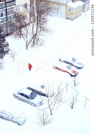 Parked cars covered with snow. Snowy day. Bad weather in the city 130971246