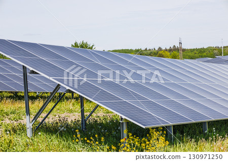 Photovoltaic Solar Array in Green Field Producing Sustainable Electricity for the Grid Photovoltaic Solar Array in Green Field Producing Sustainable Electricity for the Grid 130971250
