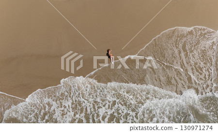 Pregnant Woman Relaxing by the Ocean Aerial Beach Photography 130971274