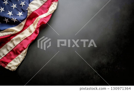 Waving Fabric of the American Flag on a Dark Background Showing Details of Stars and Stripes Waving Fabric of the American Flag on a Dark Background Showing Details of Stars and Stripes 130971364
