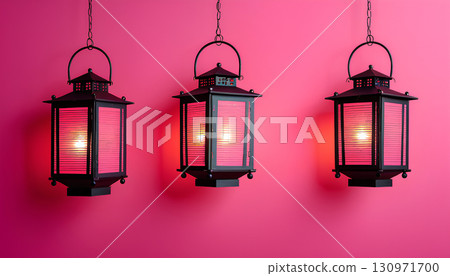 Three stylish lanterns used for interior decoration hanging on a pink wall 130971700