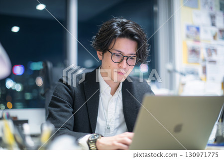 Male creator facing a computer 130971775
