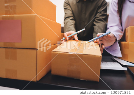 Portrait of Starting small businesses SME owners, two Asian woman check online orders Selling products working with boxs freelance work at home office, sme business online small medium enterprise 130971851