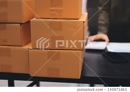 Portrait of Starting small businesses SME owners, two Asian woman check online orders Selling products working with boxs freelance work at home office, sme business online small medium enterprise Portrait of Starting small businesses SME owners, two Asian woman check online orders Selling products working with boxs freelance work at home office, sme business online small medium enterprise 130971863