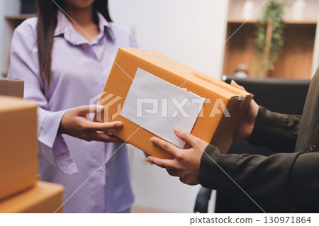 Portrait of Starting small businesses SME owners, two Asian woman check online orders Selling products working with boxs freelance work at home office, sme business online small medium enterprise Portrait of Starting small businesses SME owners, two Asian woman check online orders Selling products working with boxs freelance work at home office, sme business online small medium enterprise 130971864