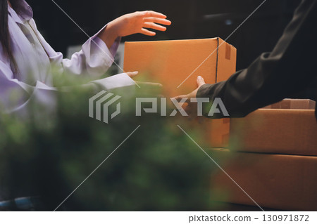 Portrait of Starting small businesses SME owners, two Asian woman check online orders Selling products working with boxs freelance work at home office, sme business online small medium enterprise Portrait of Starting small businesses SME owners, two Asian woman check online orders Selling products working with boxs freelance work at home office, sme business online small medium enterprise 130971872