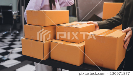 Portrait of Starting small businesses SME owners, two Asian woman check online orders Selling products working with boxs freelance work at home office, sme business online small medium enterprise Portrait of Starting small businesses SME owners, two Asian woman check online orders Selling products working with boxs freelance work at home office, sme business online small medium enterprise 130971877