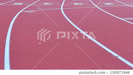 Athletics track at the stadium. Tartan track and running track. The concept of running as a journey through life. Athletics track at the stadium. Tartan track and running track. The concept of running as a journey through life. 130971946