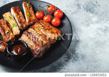 Closeup of pork ribs grilled with BBQ sauce and caramelized in honey. 130972853