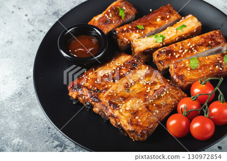 Closeup of pork ribs grilled with BBQ sauce and caramelized in honey. 130972854