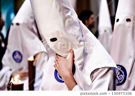 Nazarene-penitent, during the Holy Week procession in Alcala de Guadaira, Andalusia, Seville.	 130973106