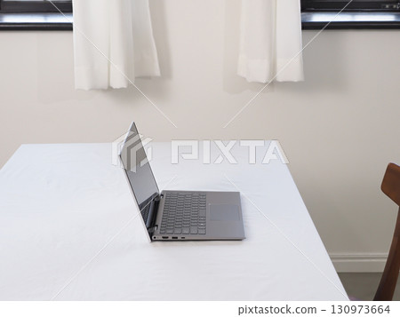 Laptop on a white table Laptop on a white table 130973664