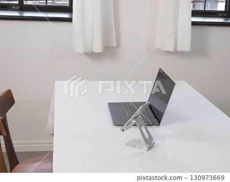 Laptop and smartphone on a white table 130973669