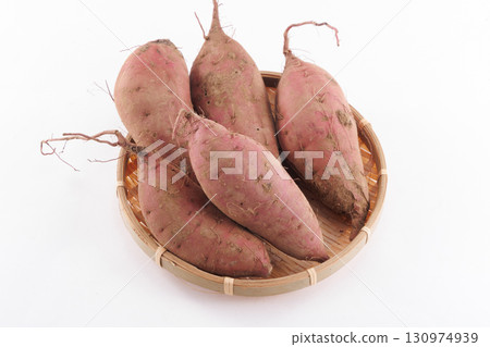 Fresh sweet potatoes in a colander 130974939