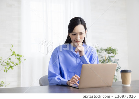 A woman using a computer A woman using a computer 130975020