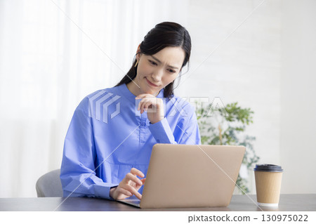A woman using a computer A woman using a computer 130975022