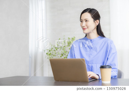 A woman using a computer 130975026