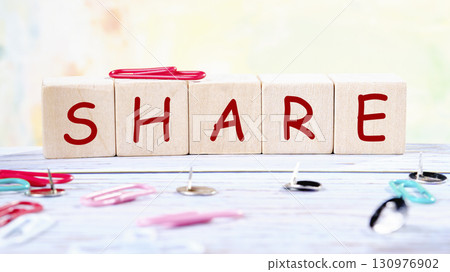 The concept word SHARE is collected of wooden cubes on an abstract background. Technology, website concept 130976902