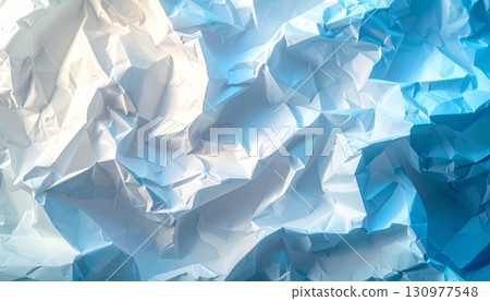 A close-up of a blue crumpled paper ball shows the intricate texture of a wrinkled and crushed wastepaper sheet A close-up of a blue crumpled paper ball shows the intricate texture of a wrinkled and crushed wastepaper sheet 130977548