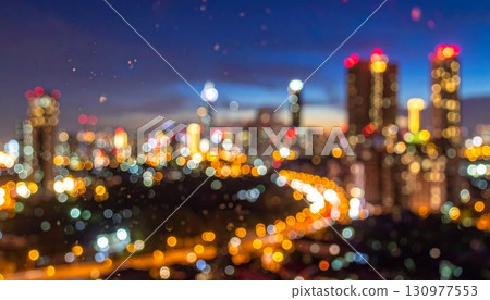 Hong Kong's vibrant night cityscape with illuminated skyscrapers reflecting on the harbor 130977553