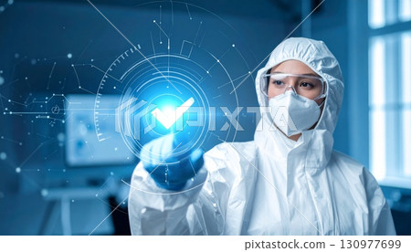 A caring female medical doctor wearing a mask and holding a syringe symbolizes the front lines of modern healthcare and medical research 130977699