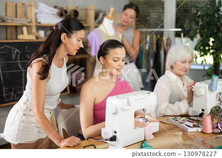 Group of women sew and work with mannequin at master class 130978227
