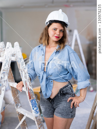Young seductive woman posing in apartment during repair works 130978235