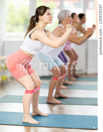 Young woman exercising with pilates band 130978397