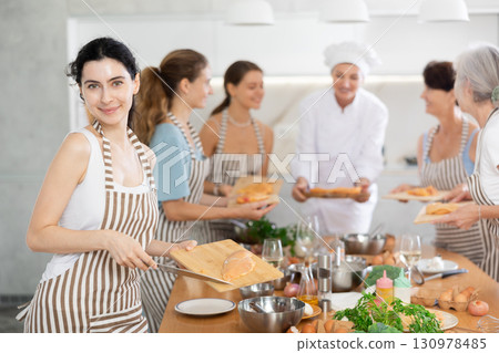 Young woman preparing chicken at master class 130978485