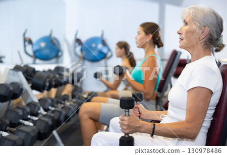 Group of women training with dumbbells in gym Group of women training with dumbbells in gym 130978486